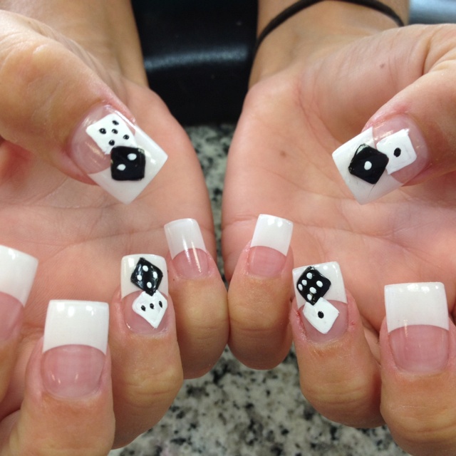 Chic French Manicure with Playful Hand-Painted Dice Design.