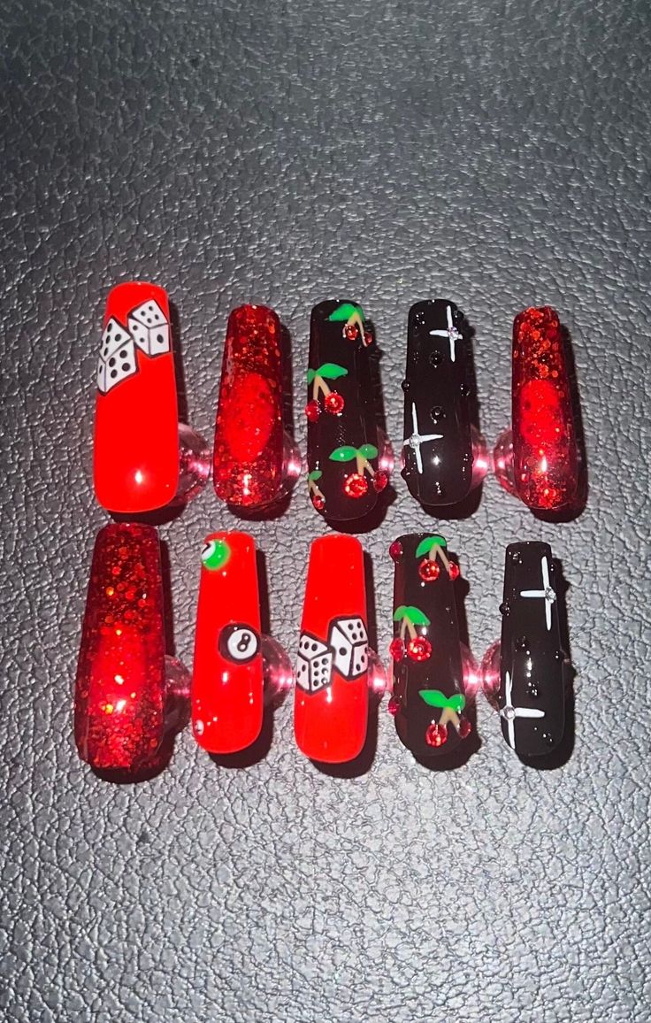 Vibrant Nail Art: Edgy Red and Black Design with Glitter and Playful Motifs.