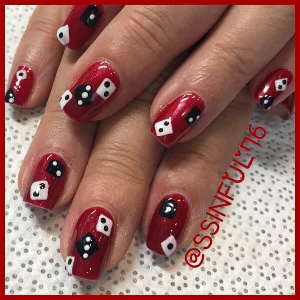 Eye-Catching Vivid Red Manicure with Whimsical Dice Designs.