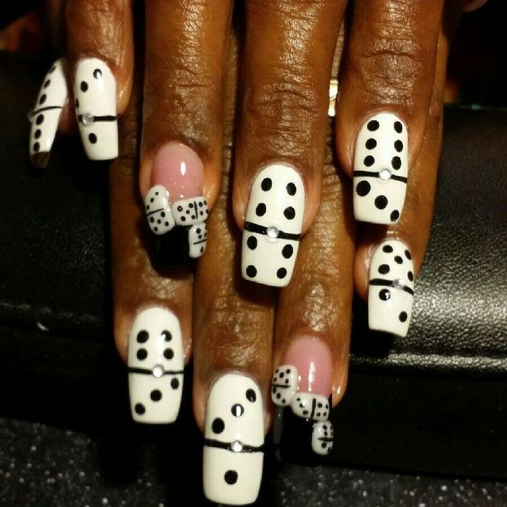 Playful Domino-Inspired Nail Design with Striking Black and White Contrast and Rhinestone Accents.