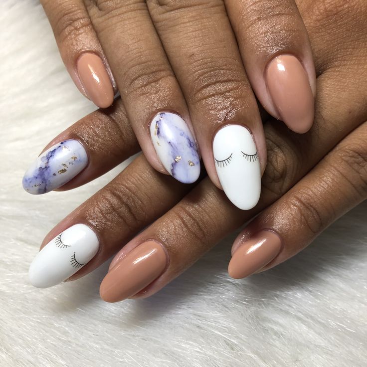 Chic Nude and Marble-Inspired Nail Design with Whimsical Eye Accents.