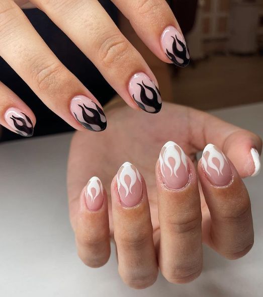 Flame-Inspired Almond Nail Design with Black and White Accents for a Bold Statement.