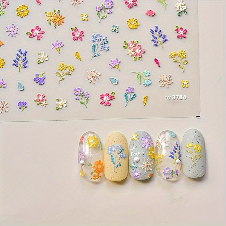 Whimsical Pastel Floral Nail Designs with Vibrant Stickers for a Playful Touch