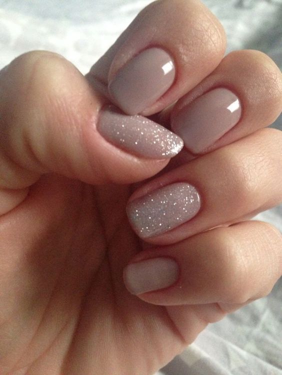 Sophisticated Nude Nail Design with Glitter Accents for Any Occasion.