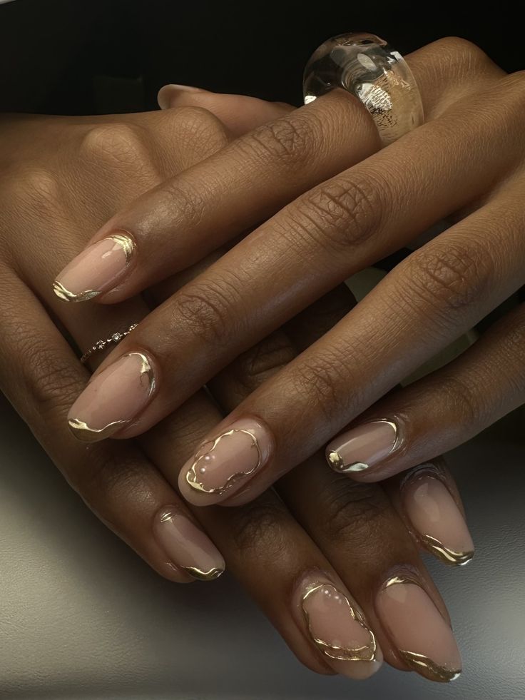 Sophisticated Nude Nail Design with Fluid Gold Accents and Wavy Lines