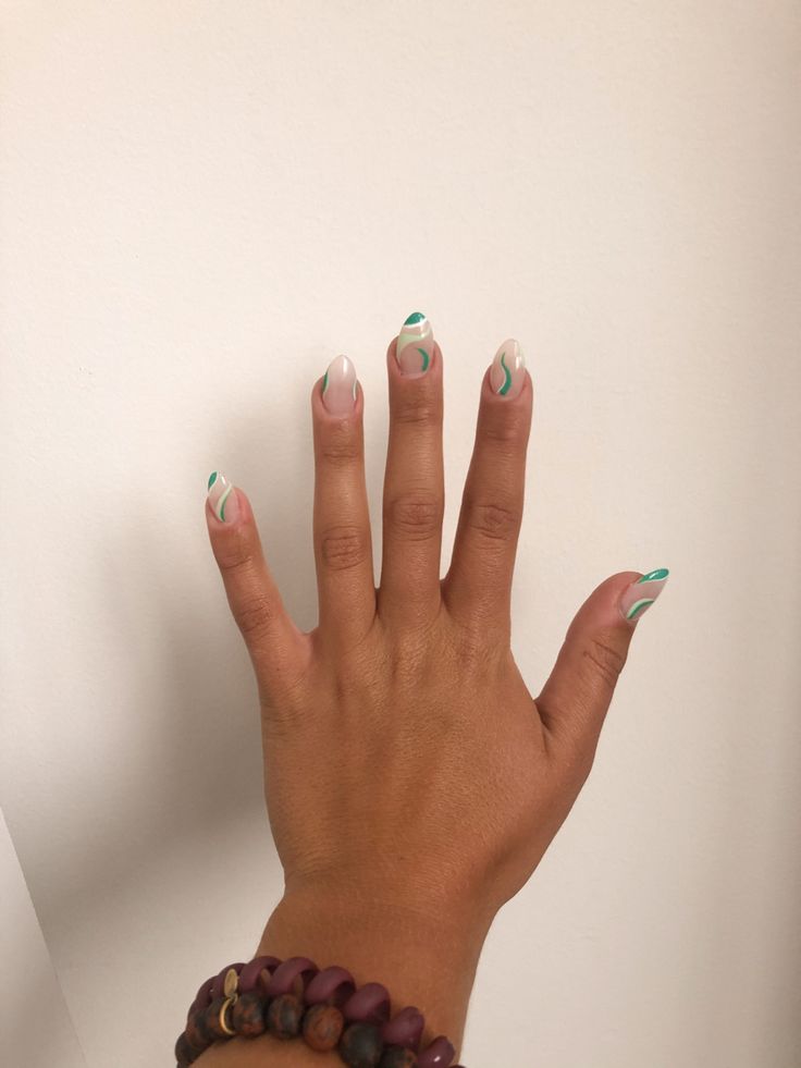 Elegant Modern Nail Design Blending Neutral and Vibrant Greens with Wavy Patterns.