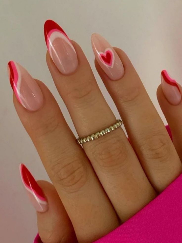 Playful Pink and Red Almond Nail Design with Wavy Lines and Heart Detail.