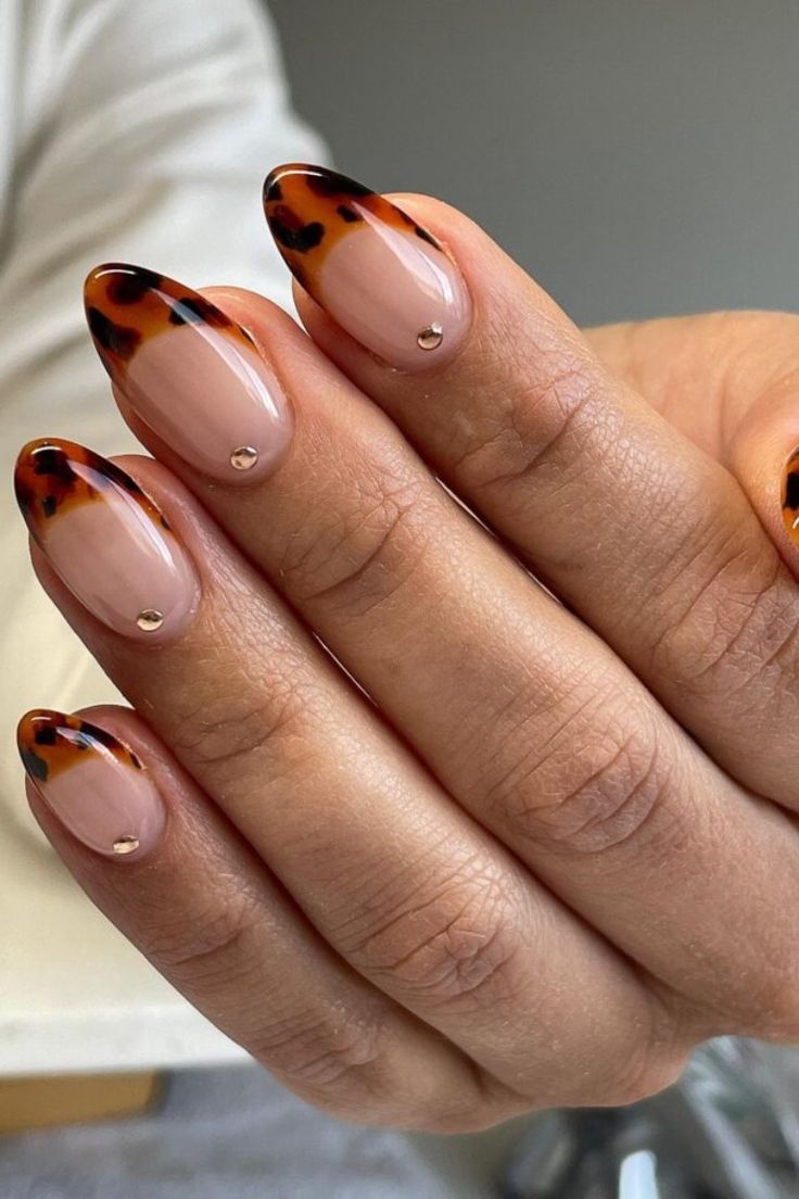 Chic Nail Design: Elegant Nude and Tortoiseshell Patterns with Glamorous Gold Accents