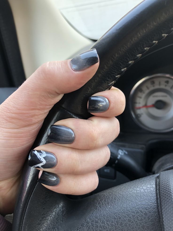 Elegant Dark Gray Nail Design with Intricate White Accent.