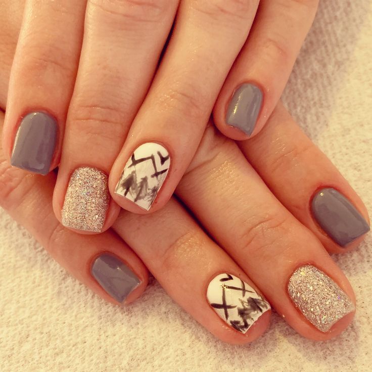 Chic Matte Gray and Glitter Nail Design with Stylish Geometric Accents.