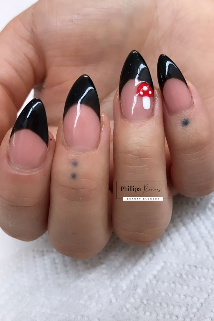 Chic Stiletto Nails with Black French Tips and Whimsical Red Mushroom Accent