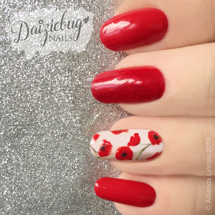 Striking Red Nail Design with Glossy, Glitter Finishes and Floral Elegance.