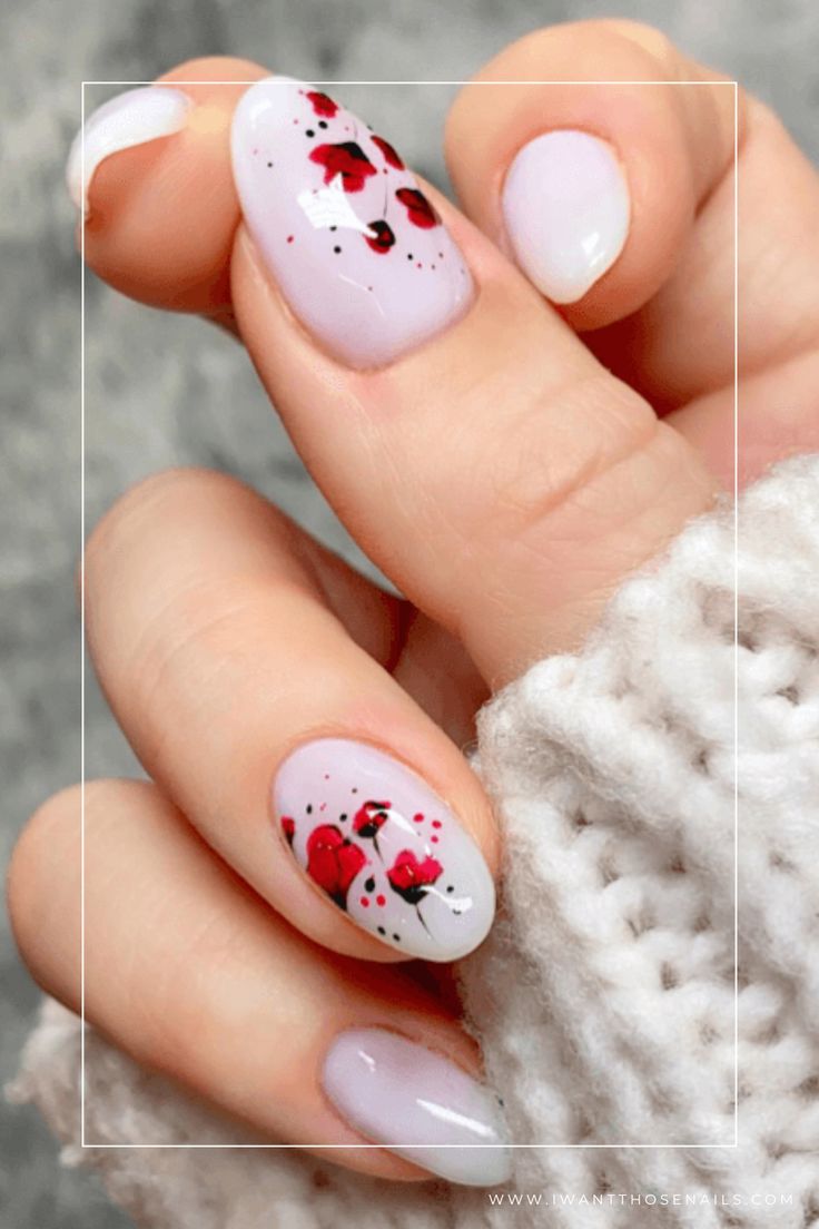 Charming Pastel Floral Nail Design with Vibrant Red Accents.