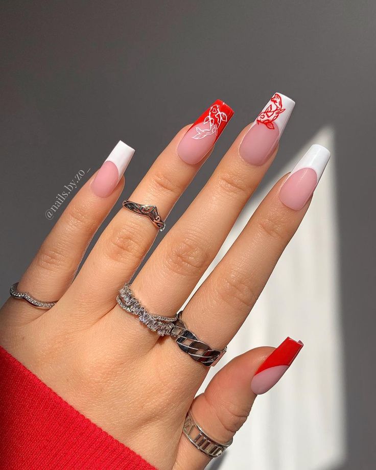 Chic French Tip Nail Design with Vibrant Red Accents and Soft Pink Base.