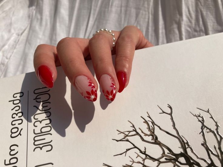 Charming Floral Nail Art with Bold Red Tips and Soft Pink Base.