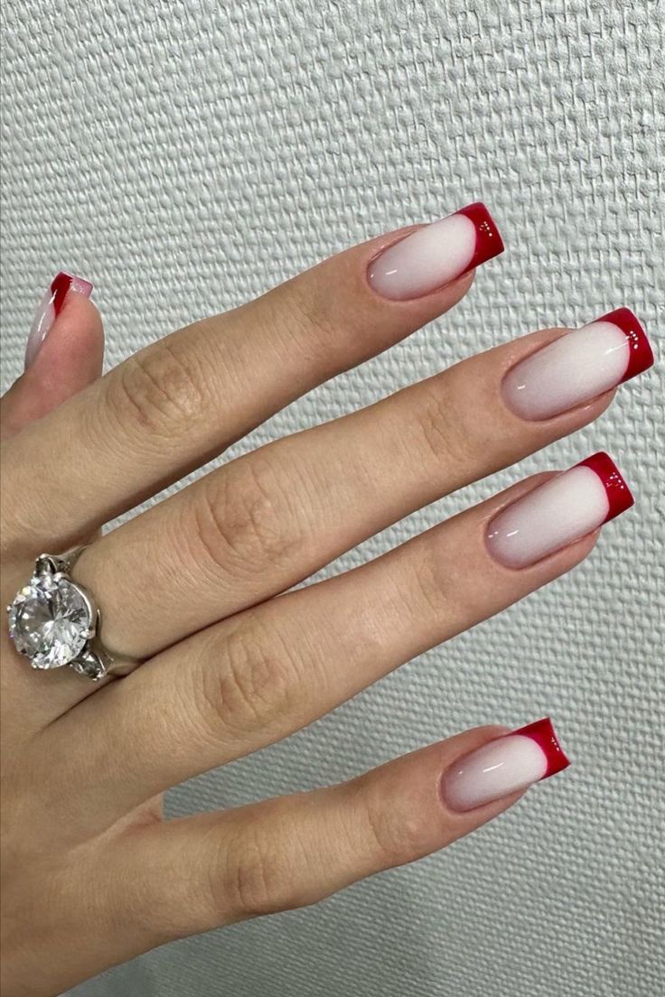 Chic Gradient Nail Design: Soft Pink Base to Vibrant Red Tips with Sparkling Accents.