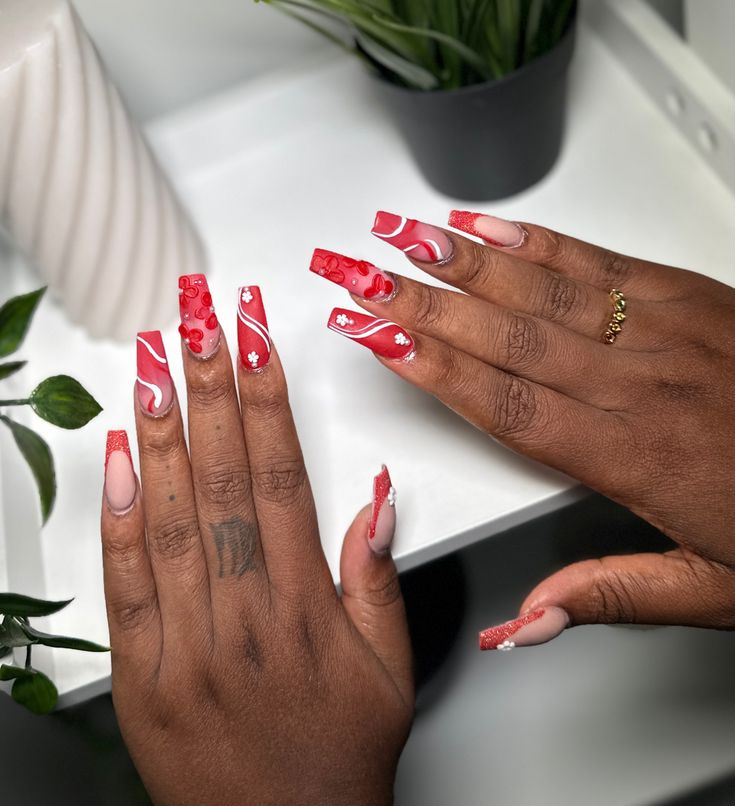 Vibrant Red and Soft Pink Nail Design with Artistic Swirls and 3D Cherry Accents for a Bold Statement.