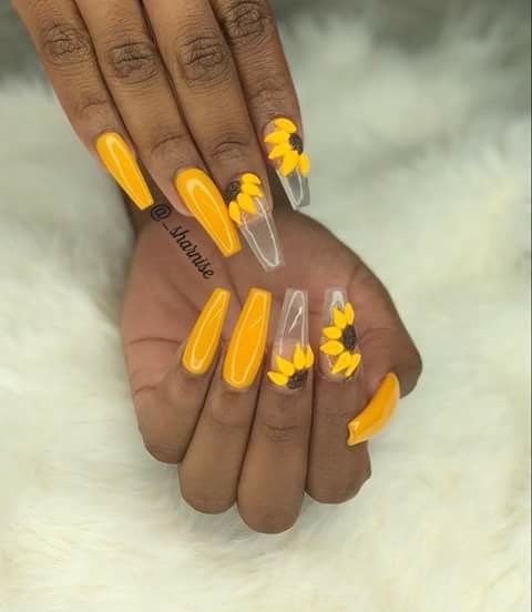 Vibrant Yellow Nail Design with Floral Accents for a Playful Summer Vibe.