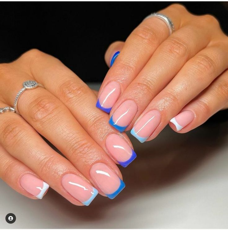 Modern French Manicure: Elegant Soft Pink Base with Bold Blue and White Tips.