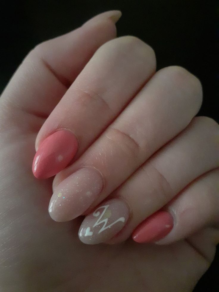 Chic Coral and Pink Gradient Nail Design with Glitter and Intricate Patterns.