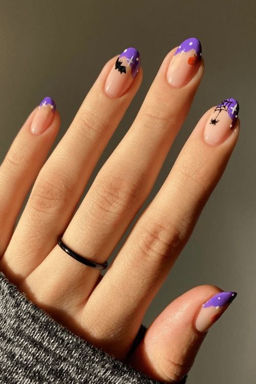 Chic Purple French Tip Halloween Nail Design with Festive Accents.