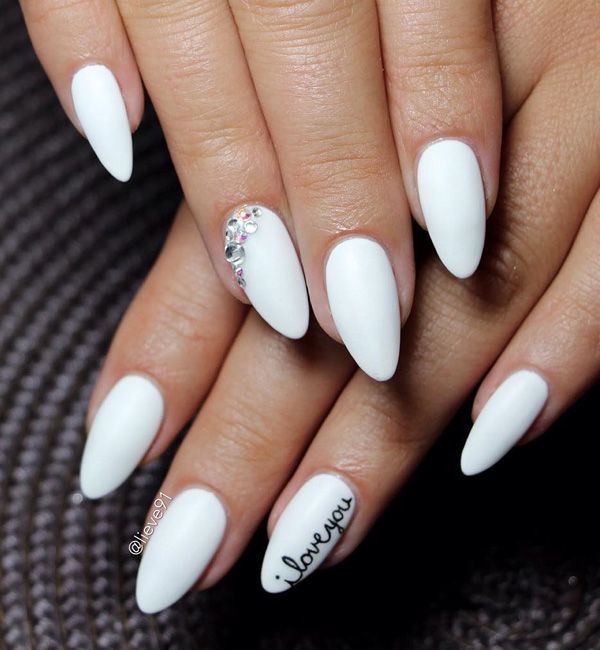 Sophisticated Matte White Almond Nails with Rhinestone Accent and Romantic Handwritten Detail.