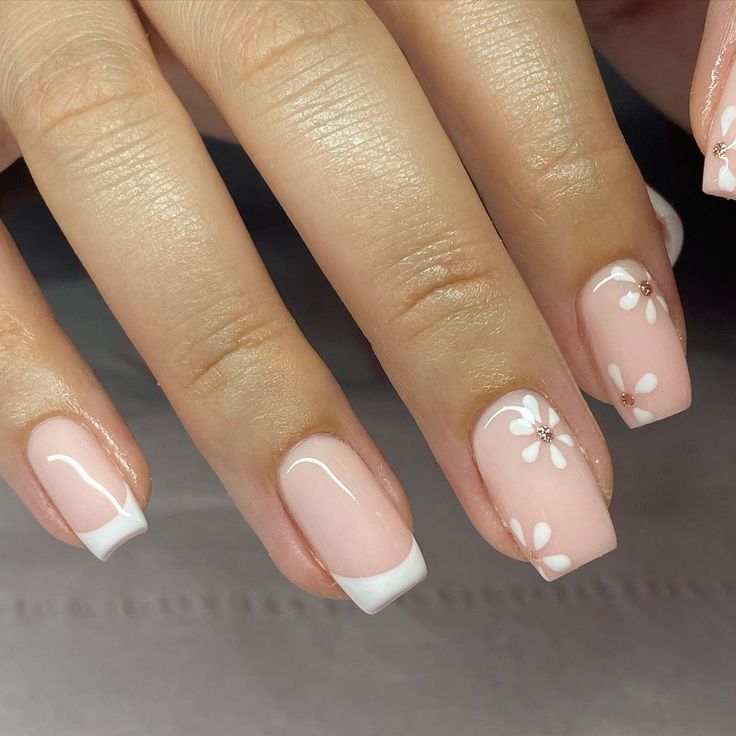 Elegant Floral Nail Design with Soft Pink Base and Sparkling Accents.