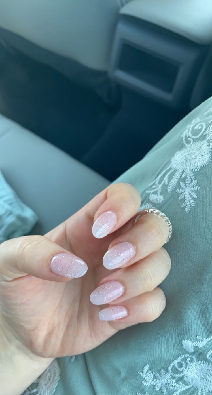 Elegant Almond-Shaped Soft Pink Gradient Nails with Subtle Sparkles for Any Occasion