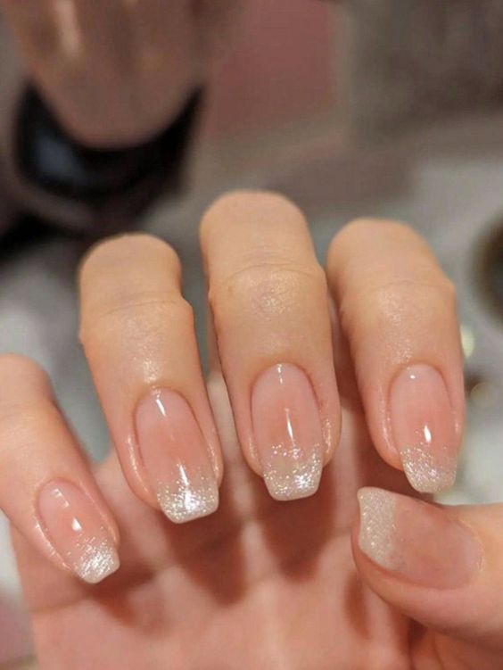 Sophisticated Elegance: Subtle Ombre Nude Nails with Sparkling Glitter Tips