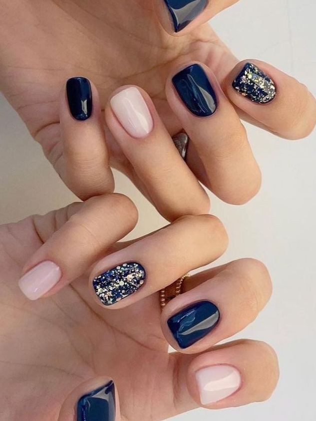 Chic Navy and Nude Nail Design with Glitter Accents for Versatile Elegance