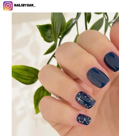 Celestial Nail Art: Elegant Navy Base with Delicate White Stars and Constellations