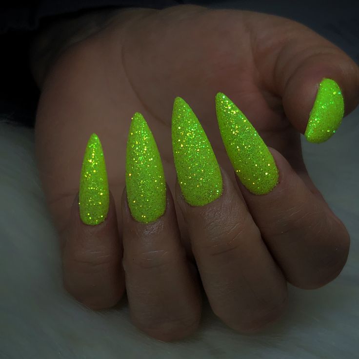 Bold Sparkling Neon Green Stiletto Nails for a Sophisticated & Playful Look.