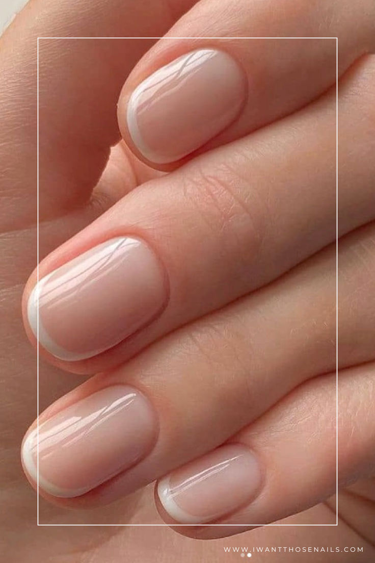 Sophisticated Nude Manicure with Subtle White Tips for a Polished Look.