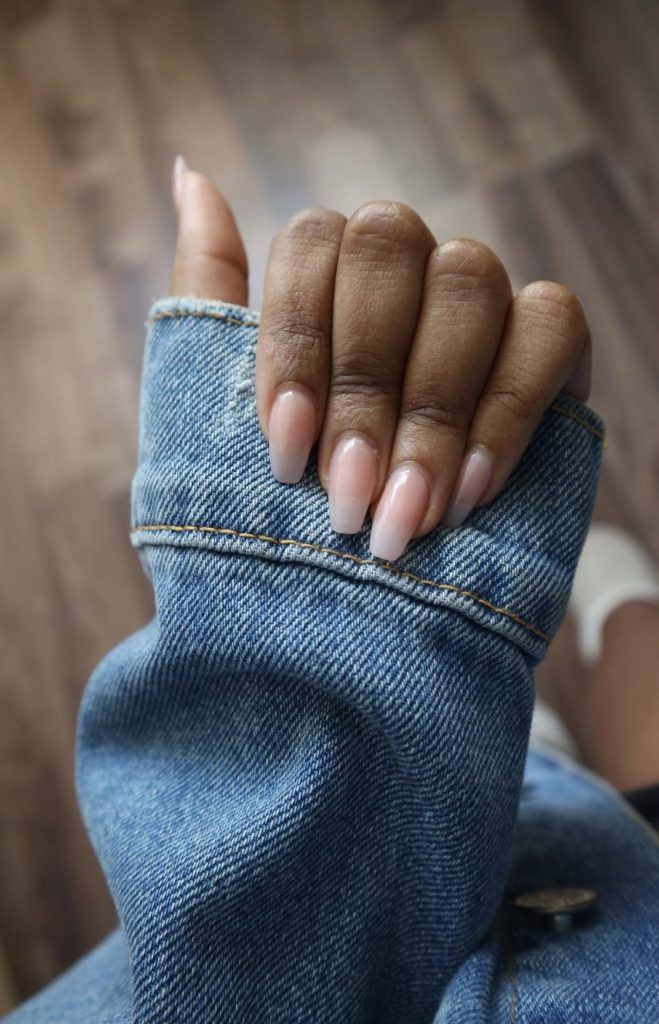 Chic Minimalist Nail Design in Soft Nude Complements Denim Outfits for Versatile Style.