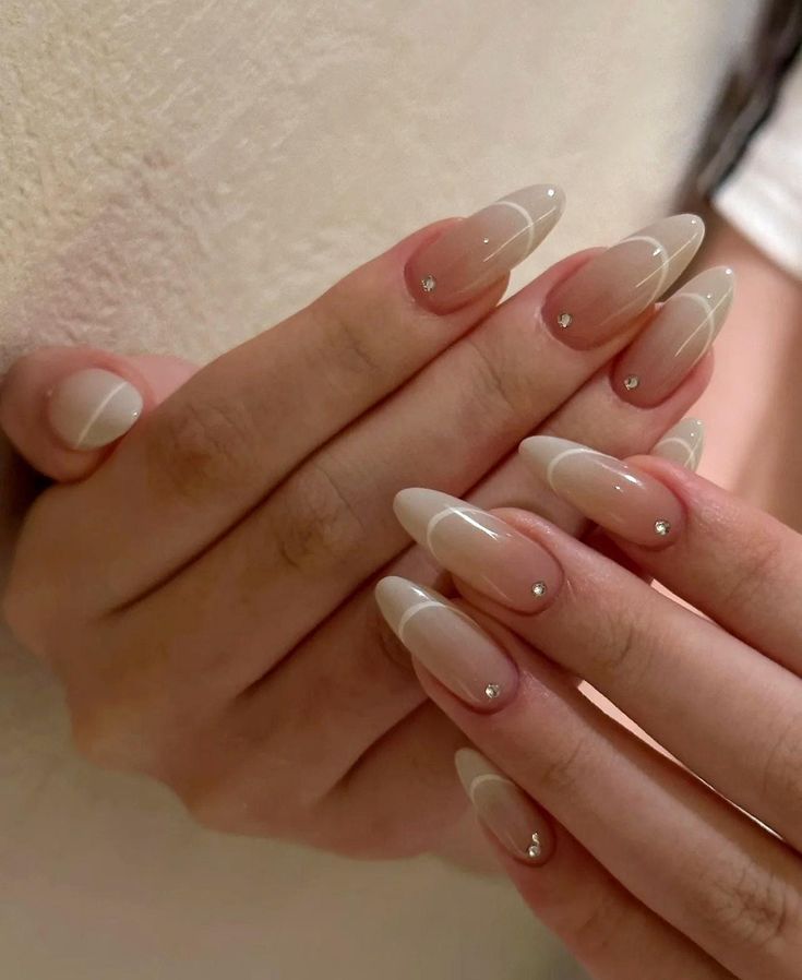 Chic Almond-Shaped Nail Art with Gradient, Intertwining Lines, and Rhinestones