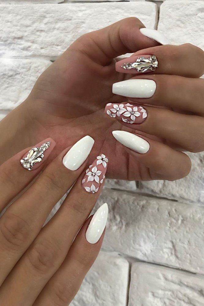 Sophisticated White and Soft Pink Nail Design with Floral Accents and Textured Elements.