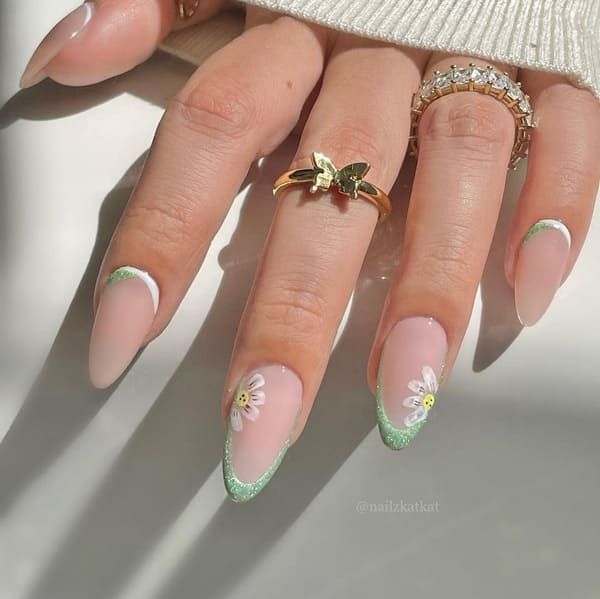 Sophisticated Nude Nail Design with Floral Accents and Statement Rings