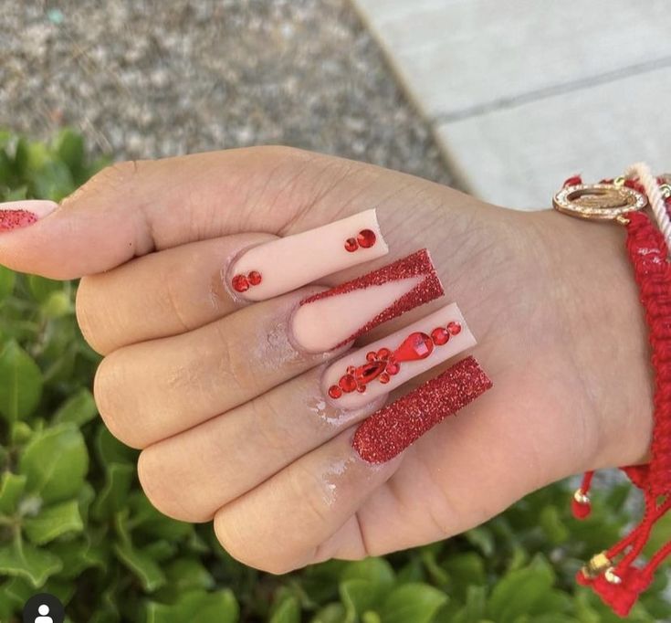 Sophisticated Nude and Deep Red Nail Design with Glitter Accents and Square Tips.