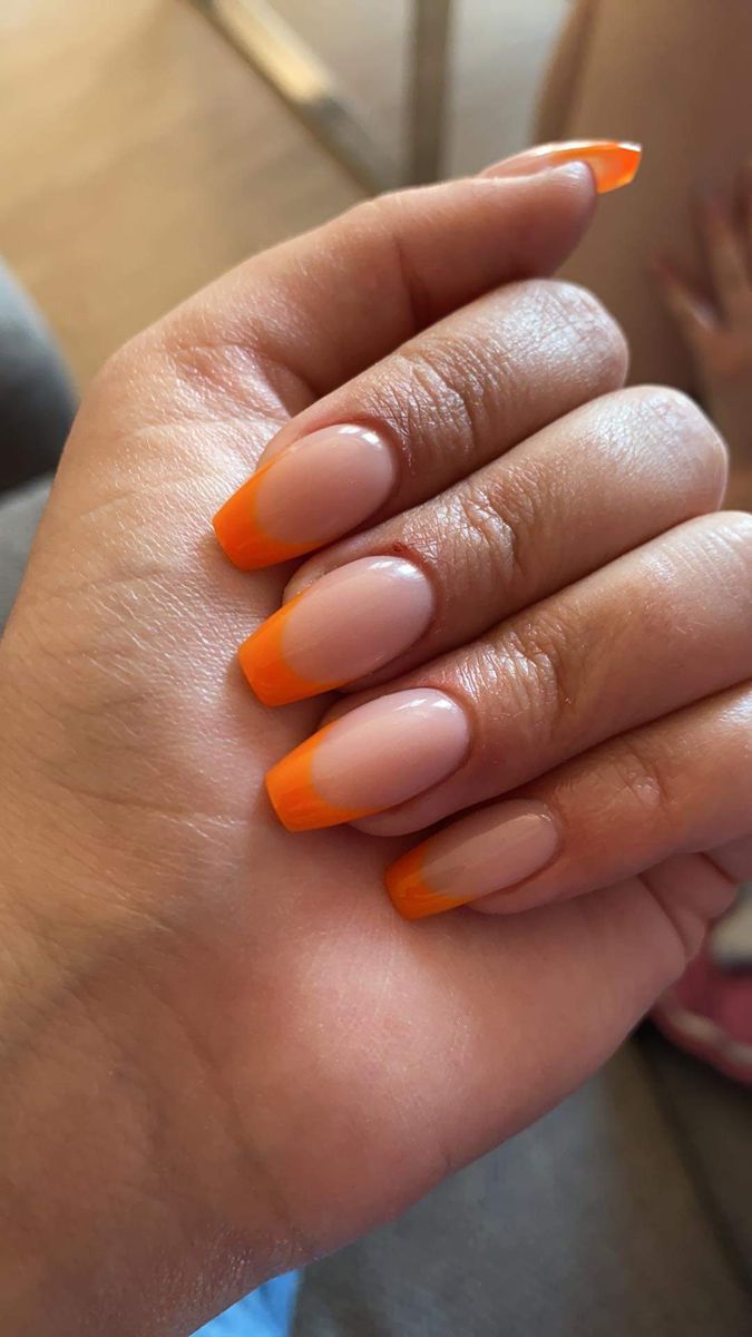 Vibrant Orange French Tips: A Playful and Elegant Summer Nail Design.