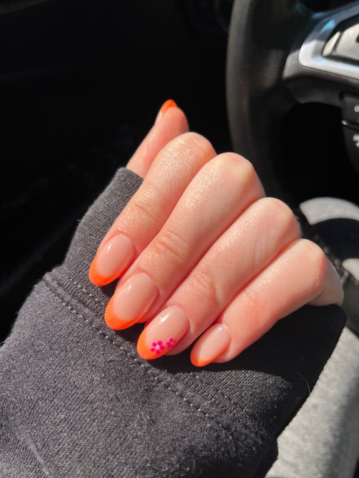 Playful Bright Orange-Tipped Nails: A Modern Twist on Classic French Design.