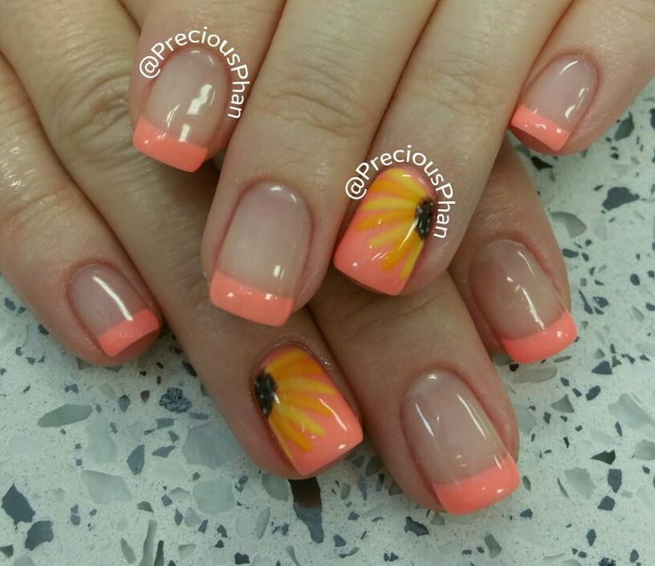 Playful Summer Nail Art: Coral Tips and Sunflower Accents on Nude Base.