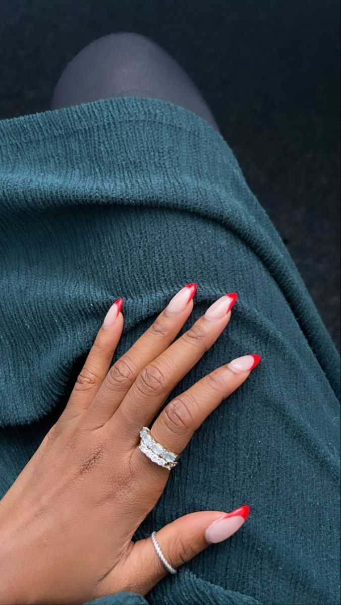 Chic Pink and Bold Red Almond Nail Design with Sophisticated Ring Accents.