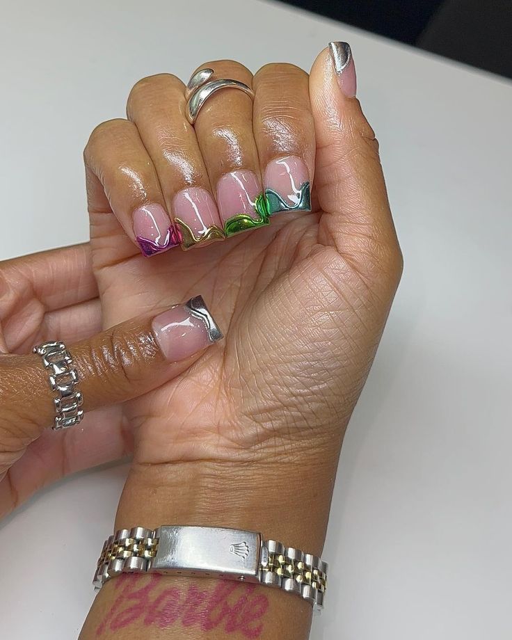 Elegant Modern French Manicure with Vibrant Swirls and Chic Metallic Accents.