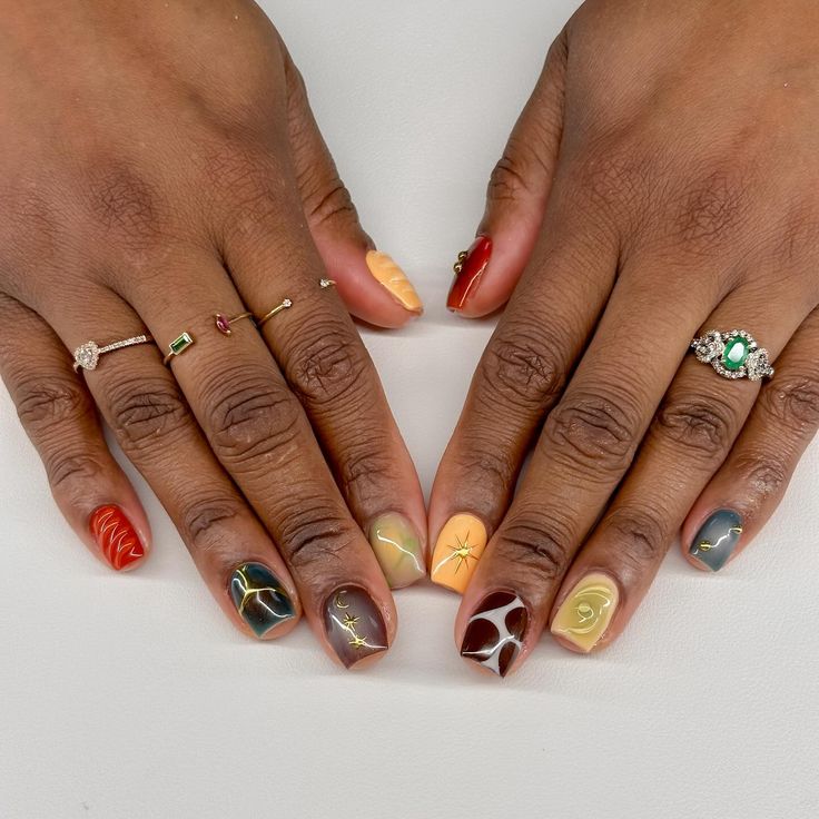 Bold and Intricate Artistic Nail Design with Earthy Tones and Abstract Accents.