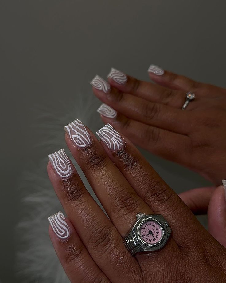 Chic Nude Base Nail Design with White Swirls for a Bold Statement.