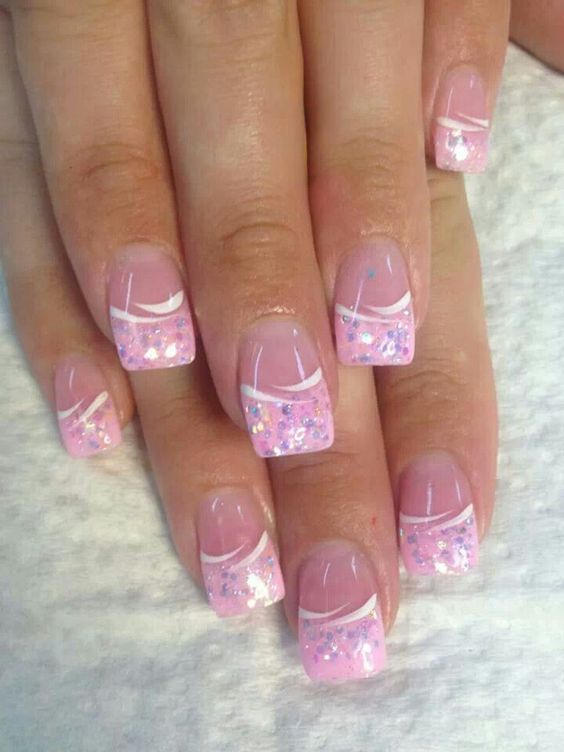 Sophisticated Soft Pink Nail Design with Glittery Tips and Delicate Accents.