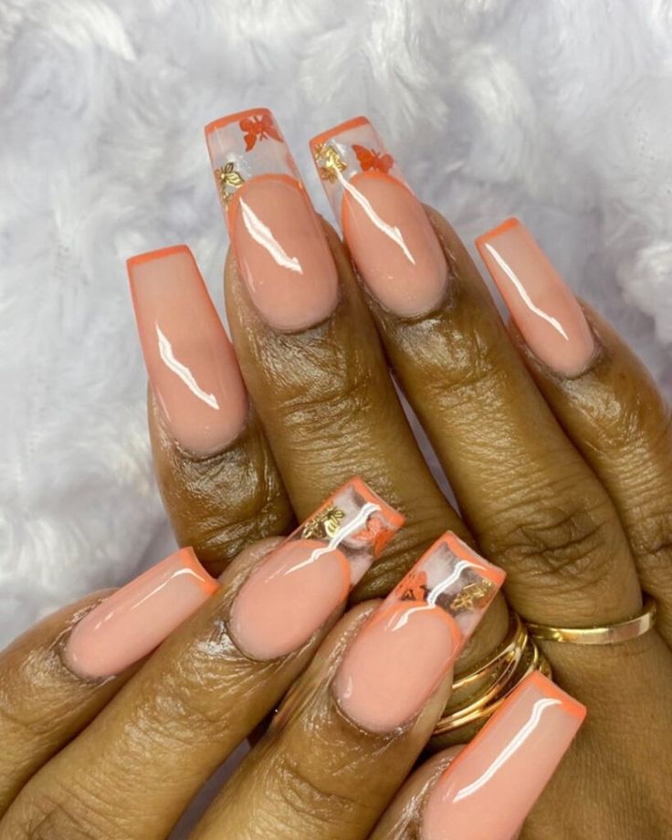 Chic Peach Nail Design with Clear Tips and Elegant Gold Floral Accents.