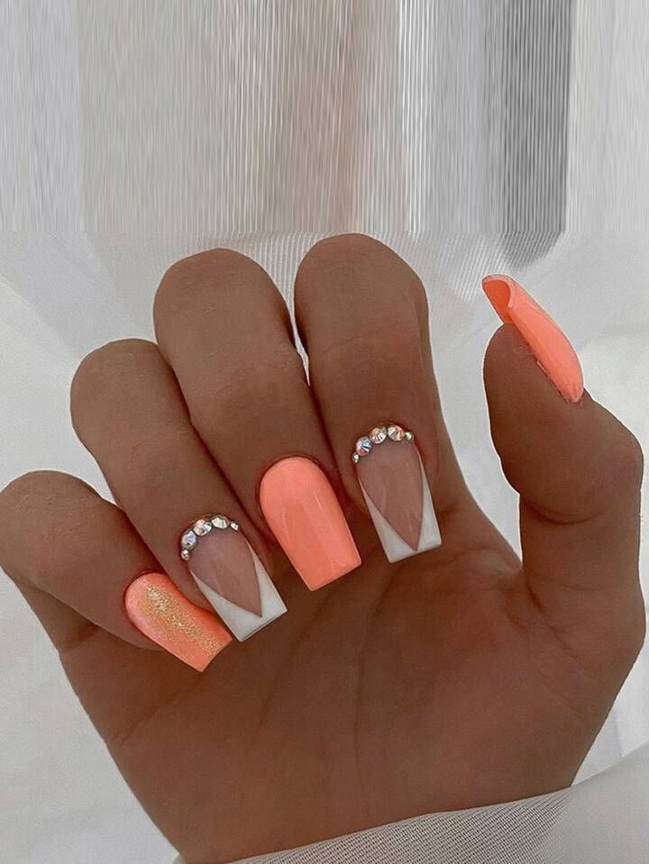 Chic Pastel Peach Nail Design with Elegant White Accents and Glamorous Rhinestone Details.