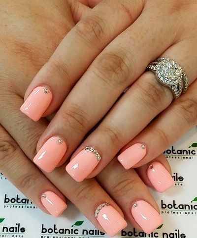 Chic Peach Nail Design with Glossy Finish and Rhinestone Accents.