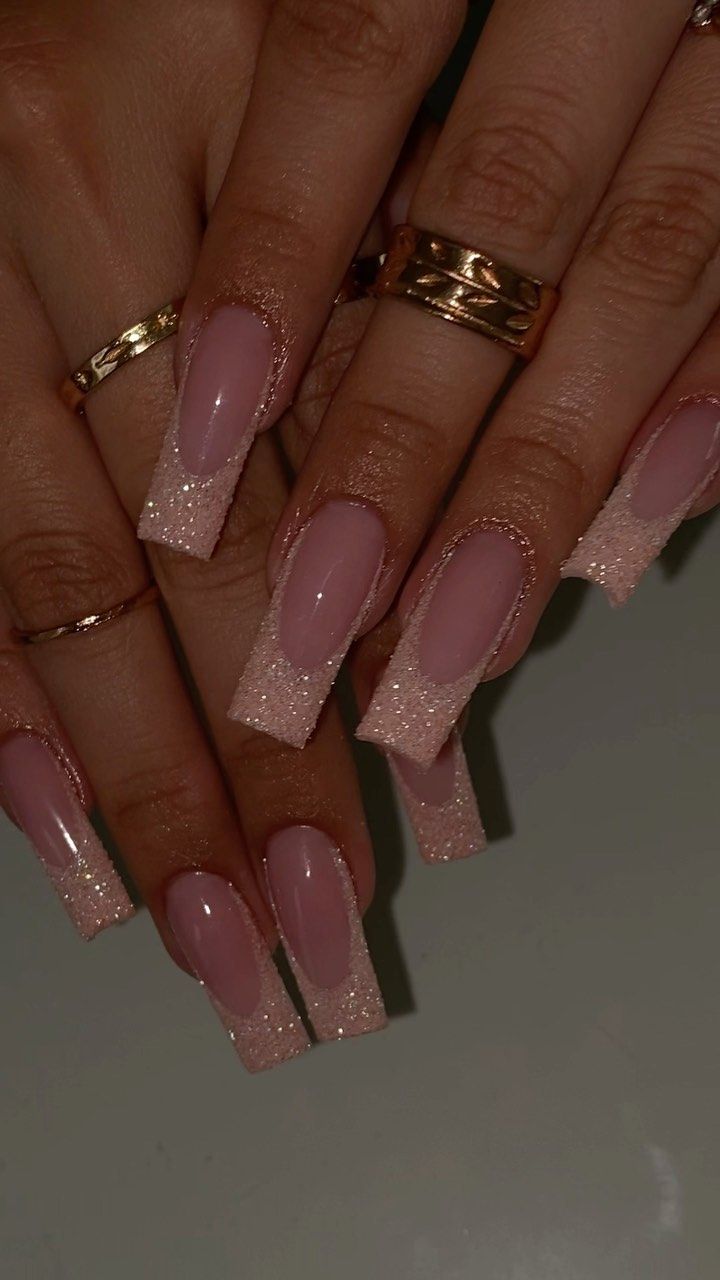 Chic Elegant Nail Design: Soft Pink Base with Glittery Tips and Delicate Rings